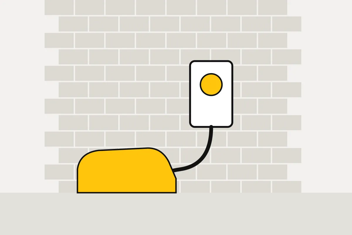 Wall-mounted EV charger next to a driveway