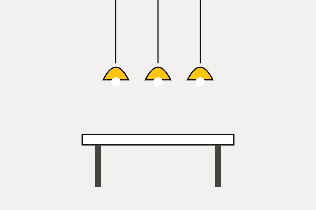 Pendant lights hanging over a dining table